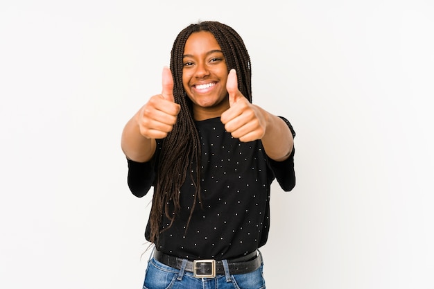 Young african american woman with thumbs ups, cheers about something, support and respect concept.