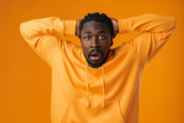 Young african anxious man worried nervous fail problem over yellow background