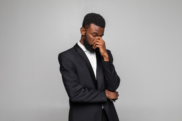 Young   African businessman wearing suit feeling sad