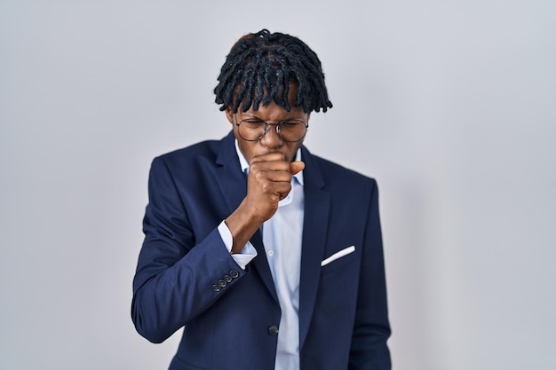 Young african man with dreadlocks wearing business jacket over white background feeling unwell and coughing as symptom for cold or bronchitis health care concept