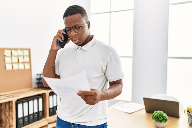 Young african man working speaking on the phone at business office