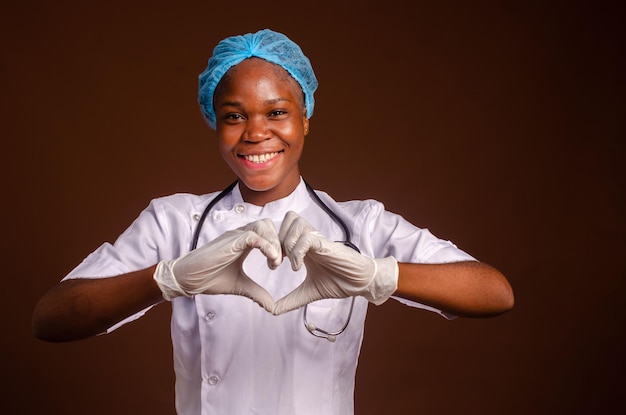 Young african nigerian woman preventing prevent prevented herself from the outbreak in his society and did a love sign