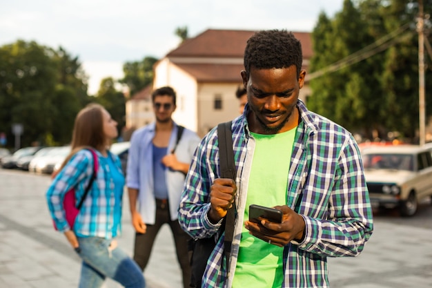 The young african student uses navigation on a smartphone