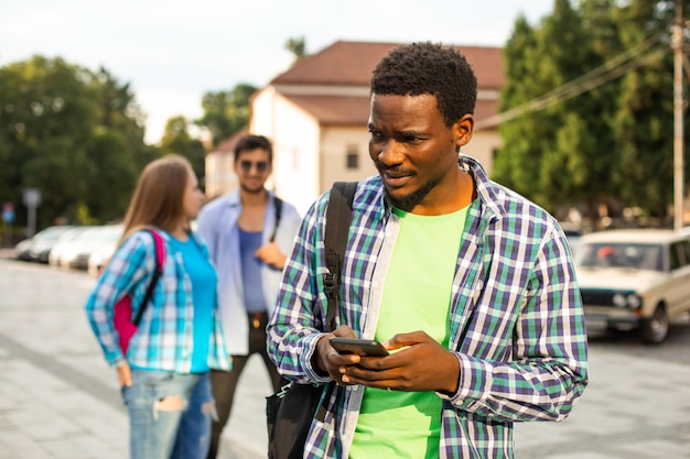 The young african student uses navigation on a smartphone