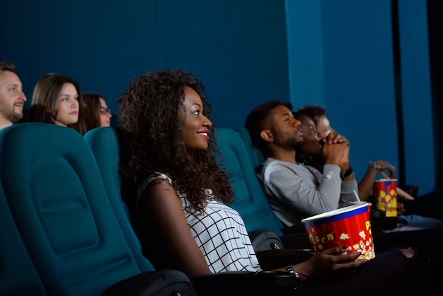 Young African woman watching a movie