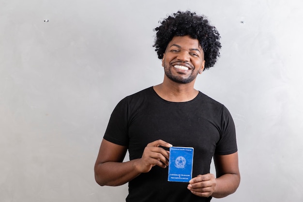 Young afro boy holding brazilian work card