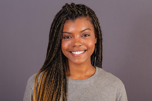 Young afro brazilian woman closeup photo showing facial expression Smiling happy joyful