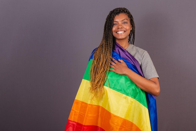 Young Afro Brazilian woman LGBT flag LGBTQ bisexual diversity Lesbian Hand on your chest