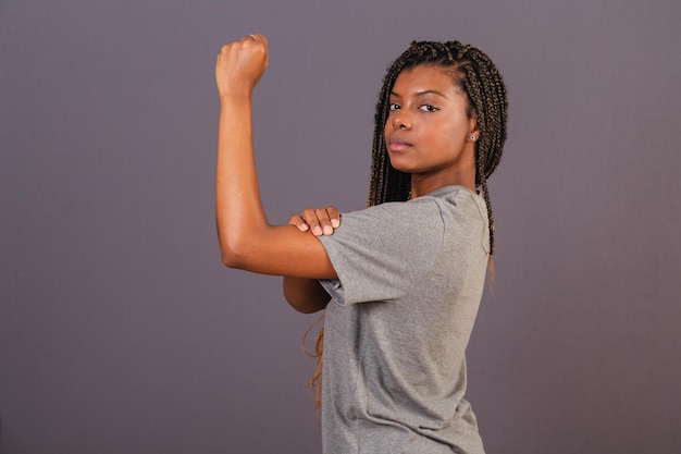 Young afro brazilian woman showing clenched fist sign of militancy female empowerment feminism