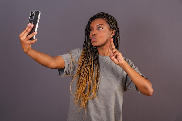 Young afro brazilian woman taking self portrait selfie photo social networks smartphone