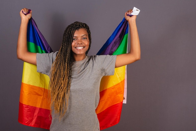 Young afro brazilian woman wearing flag as a cape LGBT LGBTQ diversity and gender equality