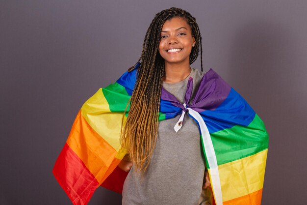 Young afro brazilian woman wearing flag as a cape LGBT LGBTQ diversity and gender equality