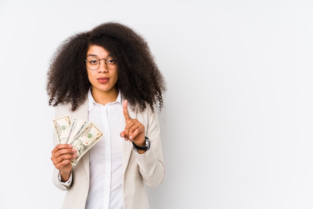 Young afro business woman holding a credit card showing number one with finger