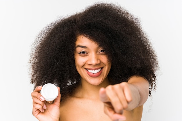 Young afro woman holding a moisturizer