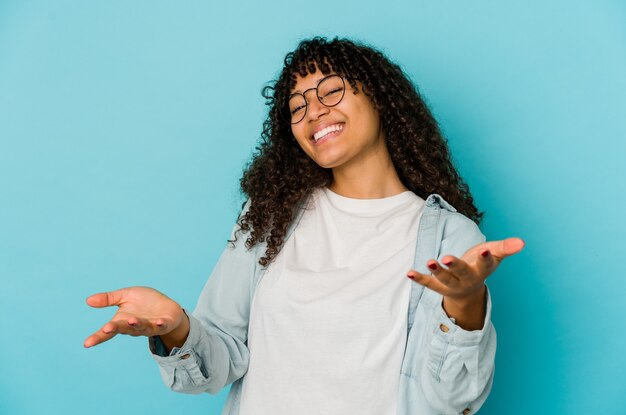 Young afro woman isolated showing a welcome expression