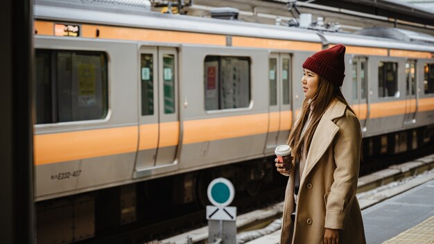 Young aisan woman waiting Train at platform