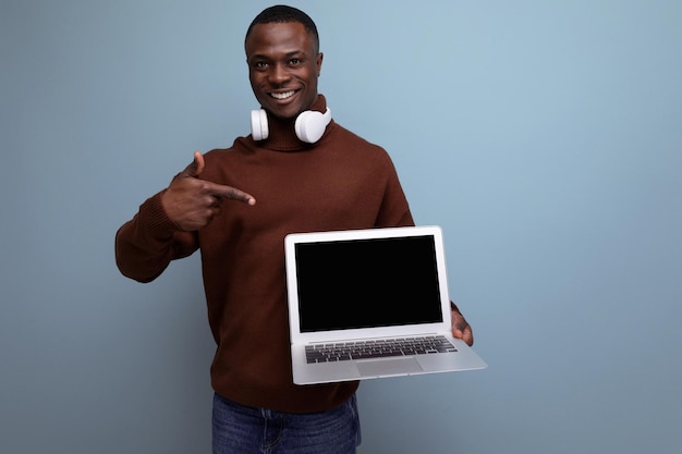 Young american brunette service employee repaired a laptop on the background with copy space