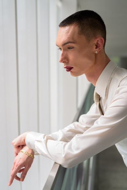 Young androgynous homosexual LGTB businessman wearing lipstick