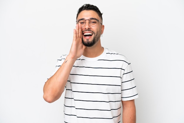 Young Arab handsome man isolated on white background shouting with mouth wide open