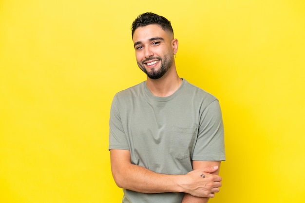 Young Arab handsome man isolated on yellow background laughing