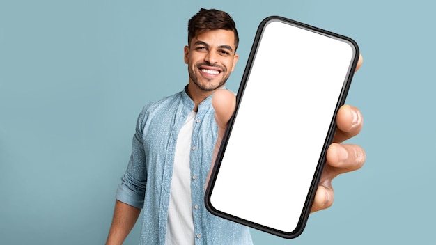 Young Arab Man Showing Phone With Blank Screen