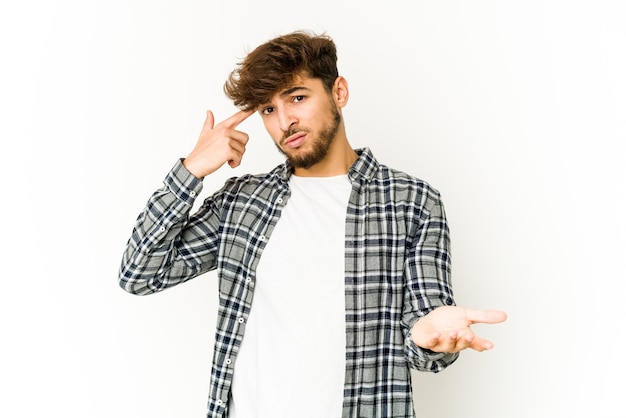 Young arab man on white space holding and showing a product on hand.