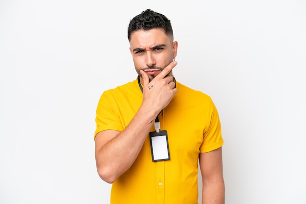 Young Arab man with ID card isolated on white background thinking