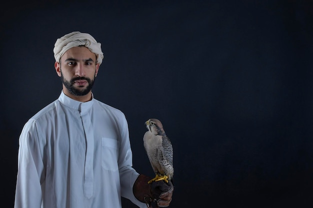 Young Arab prince holding a bird of prey. 