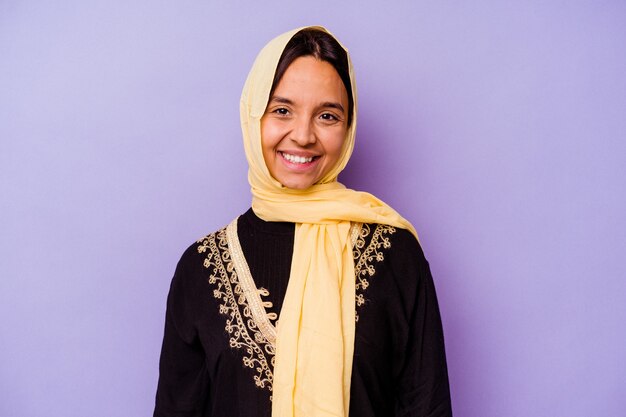 Young arab woman wearing a typical Arabian costume isolated on purple background happy, smiling and cheerful.