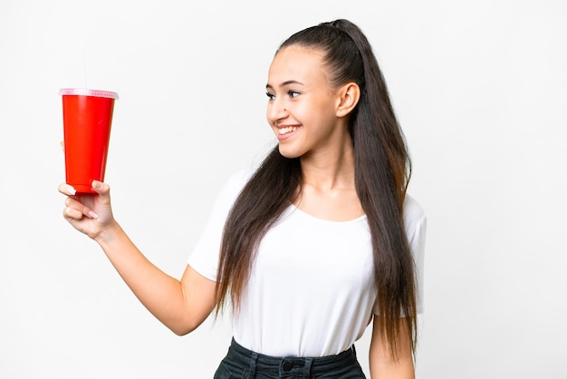 Young Arabian woman holding soda over isolated white background with happy expression