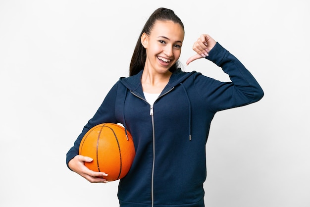 Young Arabian woman over isolated white background playing basketball and proud of himself