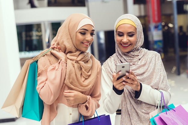 Young Arabian Women Using Smartphone with Friend