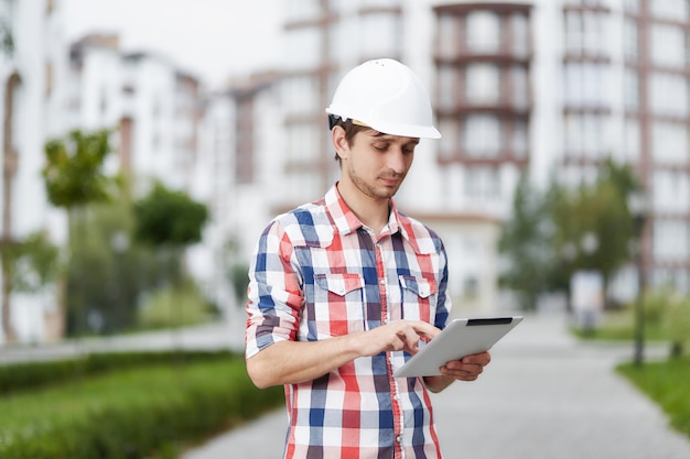 Young architect in front of apartment building