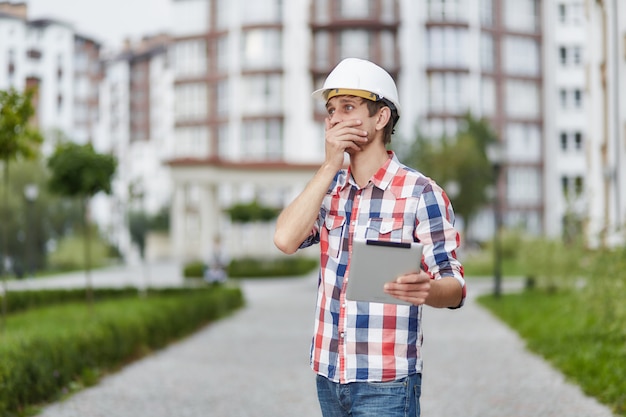 Young architect in front of apartment building