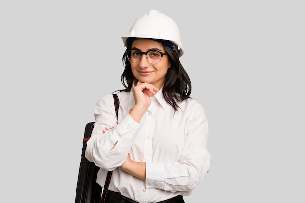 Young architect indian woman with helmet and holding a meter cut out isolated