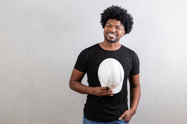 Young architect man wearing builder safety helmet over isolated background with a happy and cool smile on face Lucky person