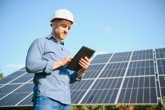 Young architect standing by solar panels