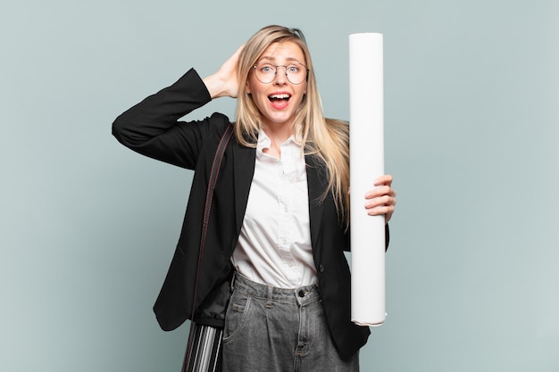 Young architect woman feeling stressed, worried, anxious or scared, with hands on head, panicking at mistake