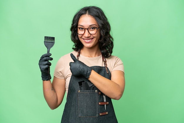 Young argentinian hairdresser woman over isolated background giving a thumbs up gesture