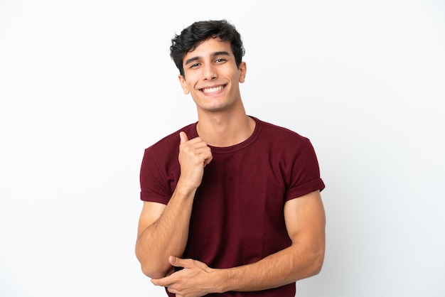 Young Argentinian man isolated on white background laughing