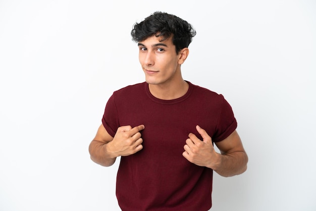 Young Argentinian man isolated on white background pointing to oneself