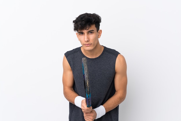 Young Argentinian man over isolated white wall playing tennis