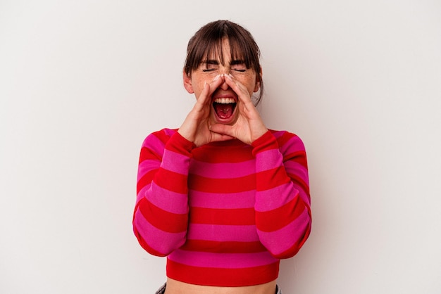 Young Argentinian woman isolated on white background shouting excited to front.