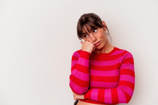 Young Argentinian woman isolated on white background who feels sad and pensive, looking at copy space.