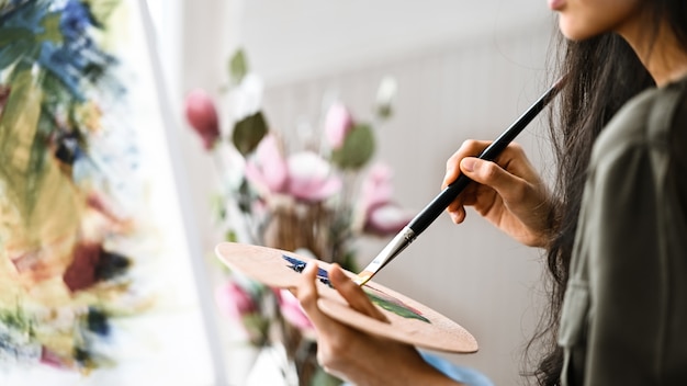 young artist girl  drawing canvas while painting an oil colour.