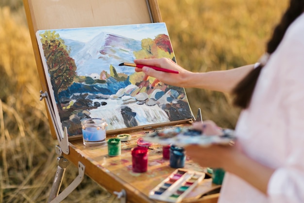 Young artist hand painting in the nature