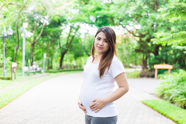 Young Asia pregnant in beautifull garden