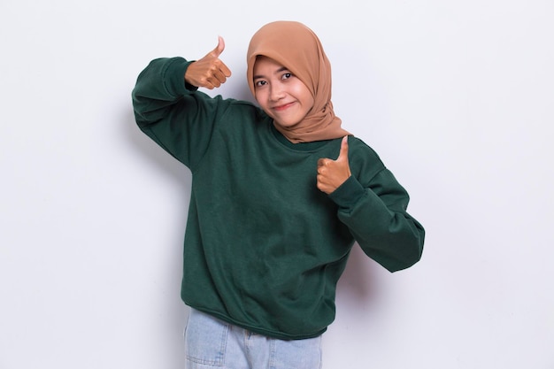 young asian beautiful muslim woman with ok sign gesture tumb up isolated on white background