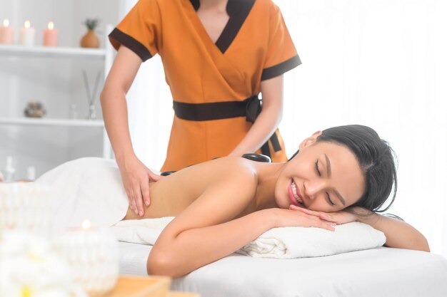 Young asian beautiful woman relaxing and enjoying massage spa and beauty treatment concept