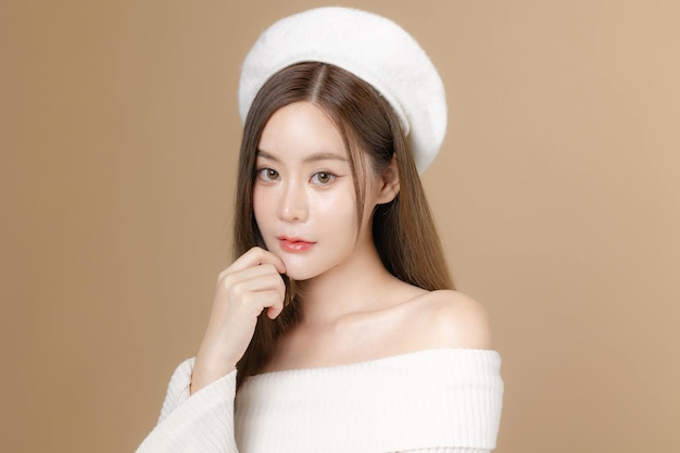 Young Asian beauty woman long hair with beret lovely face and perfect clean skin on isolated beige background Female model Facial treatment Cosmetology plastic surgery